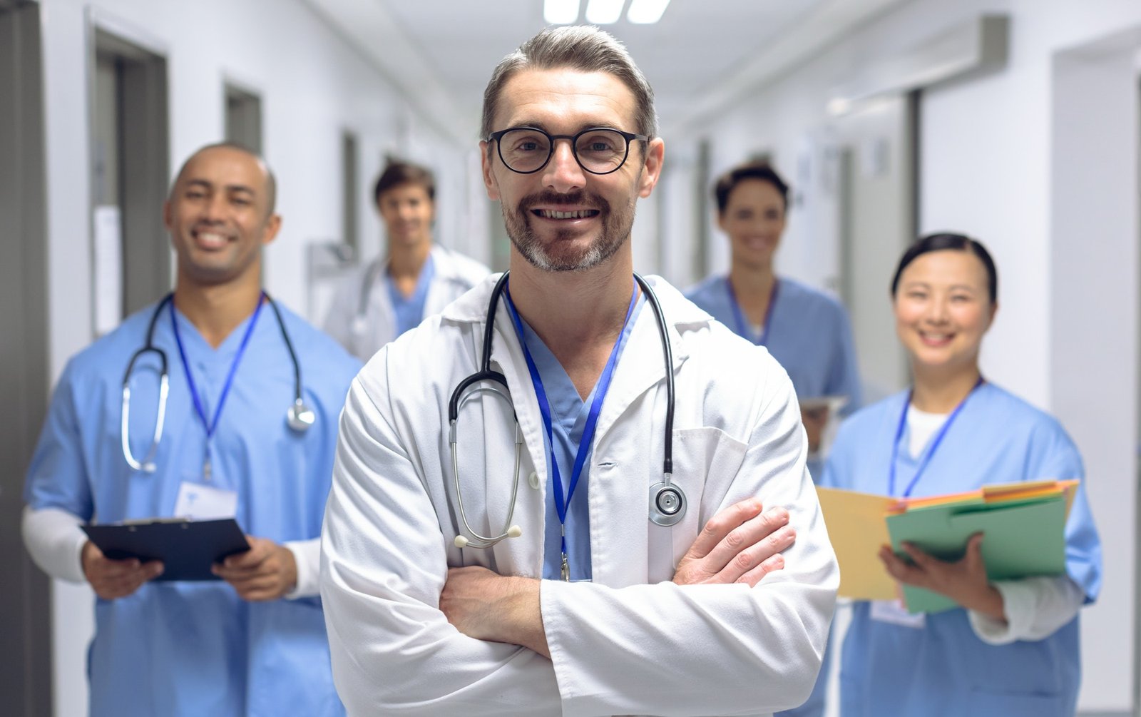 diverse-medical-team-of-doctors-looking-at-camera-while-holding-clipboard-and-medical-files.jpg